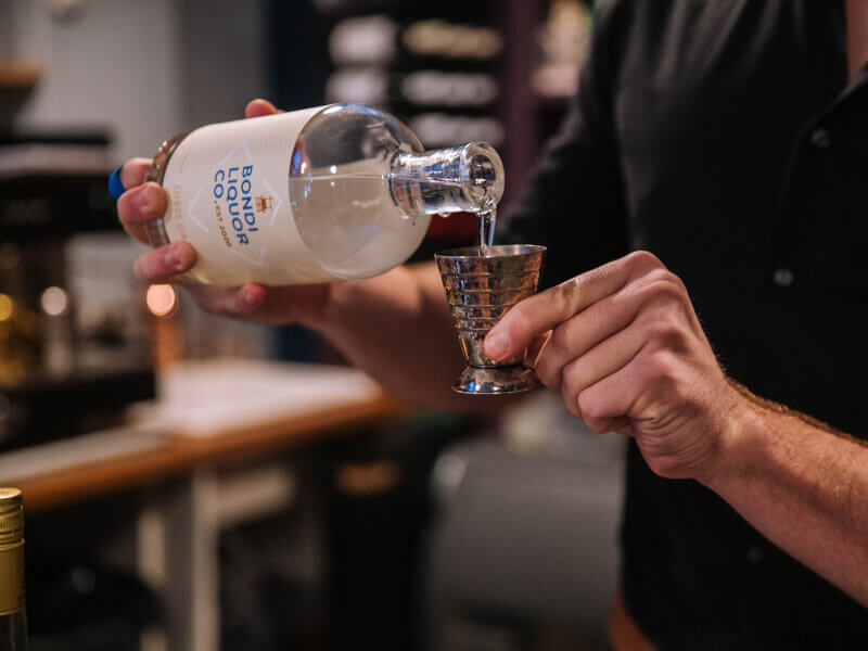 Man pouring alcohol in a jigger